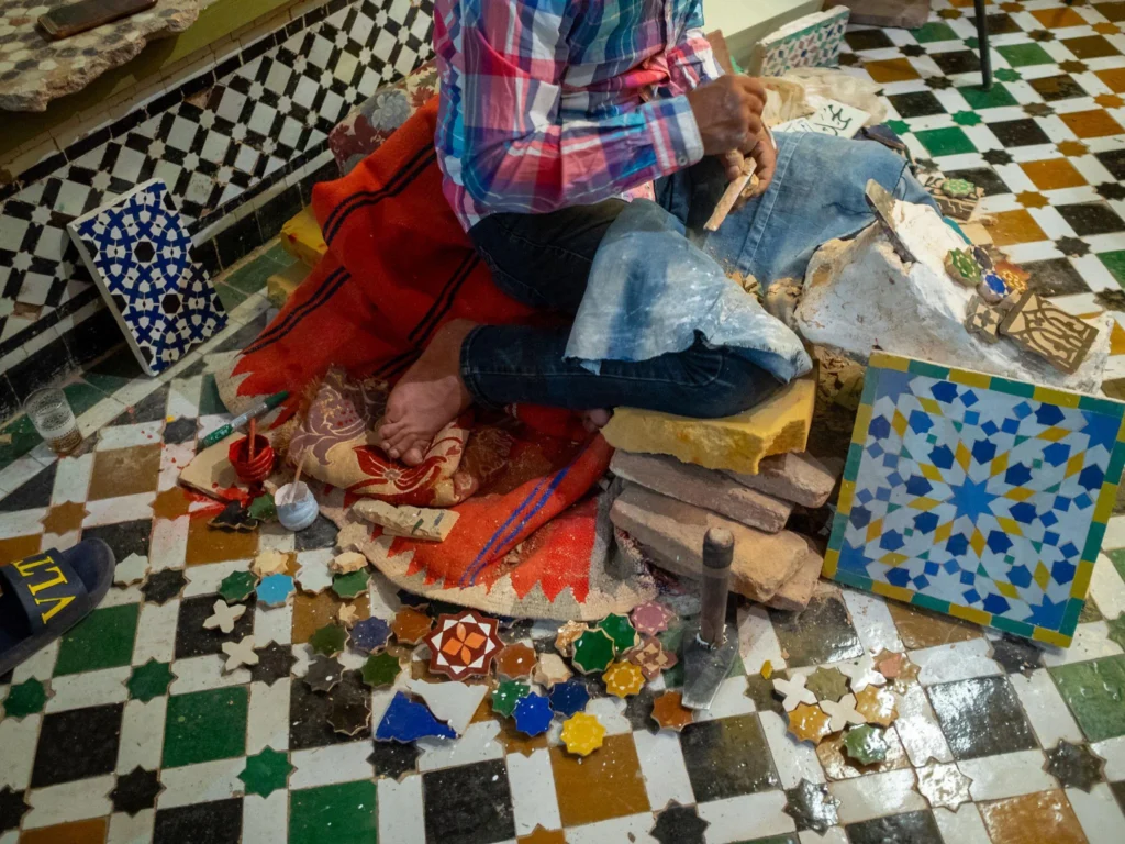 Political and Economic Importance of Marrakech. a man creating moroccan mosaic